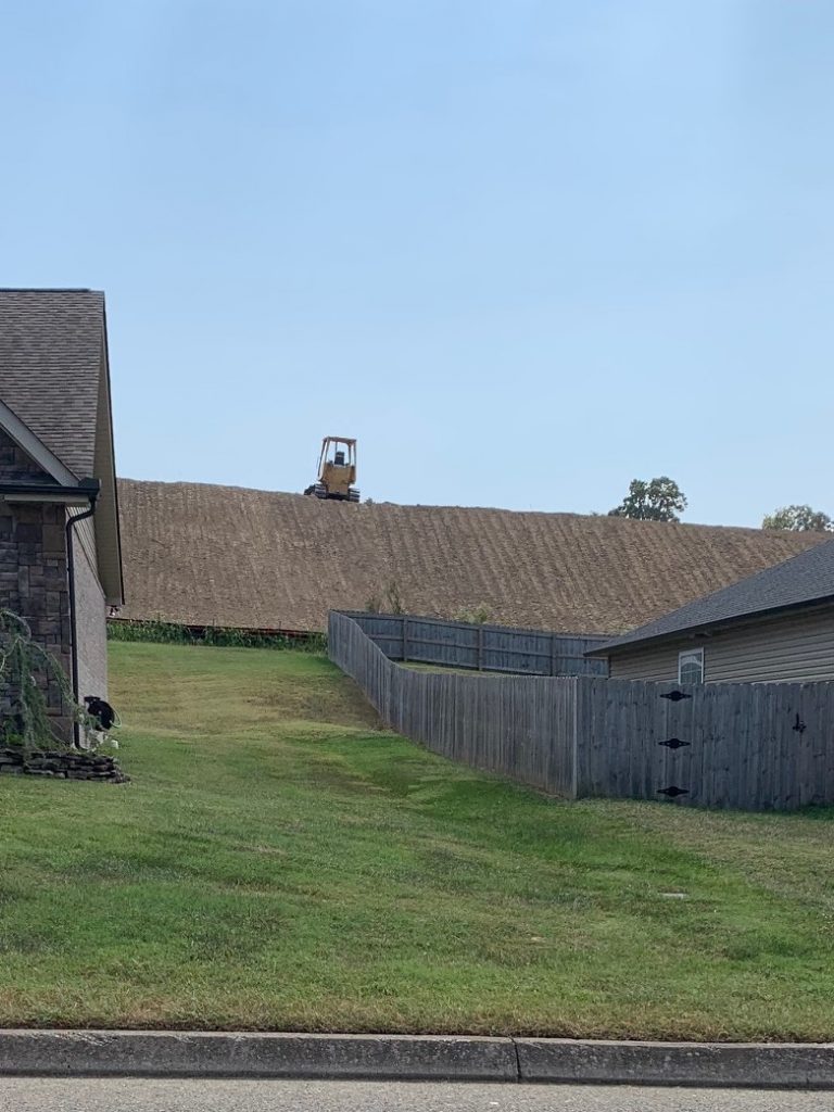 image of earth-moving equipment atop tall hill